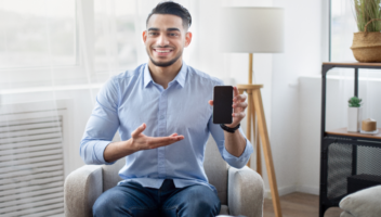 A focused therapist using a digital device to enhance schema therapy training techniques, representing modern mental health advancements and professional development for psychotherapists.