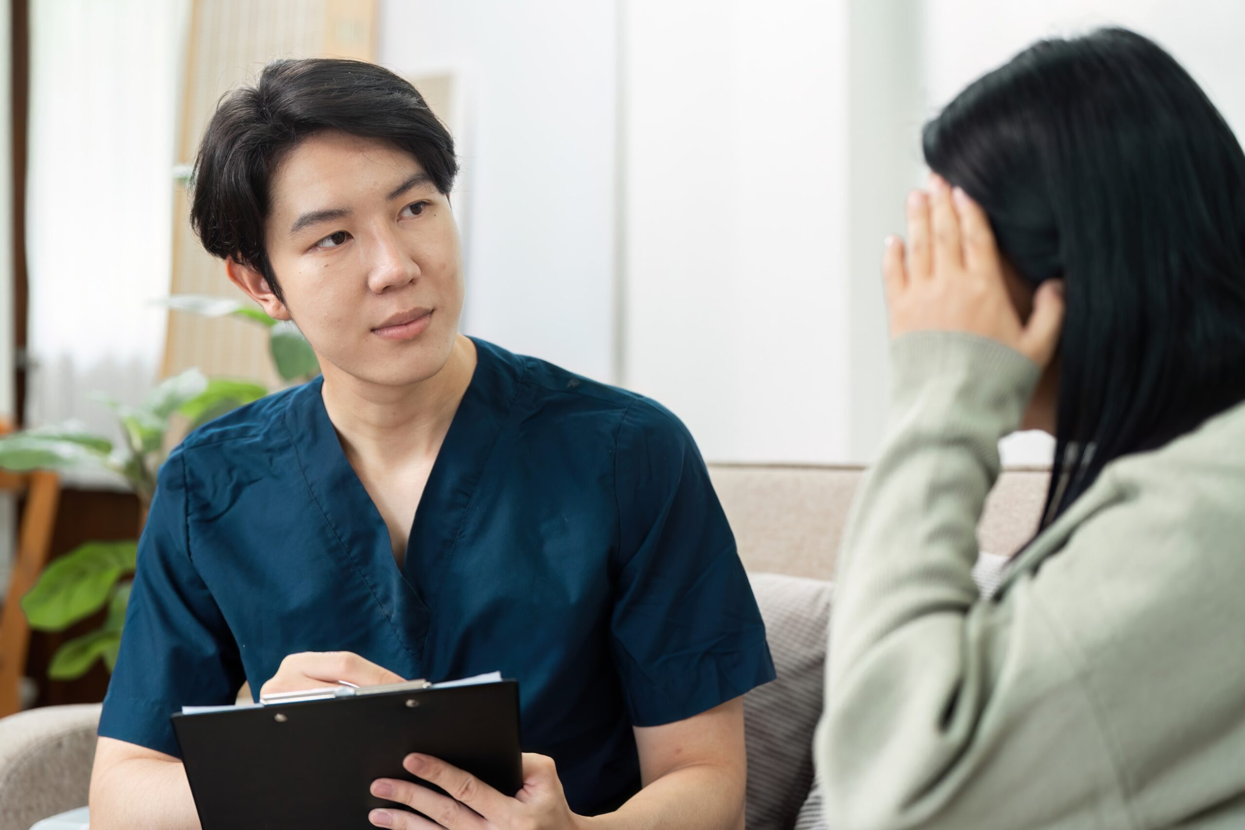 Image of Asian schema therapist using empathic confrontation to help a client suffering from subjugation schema issues.
