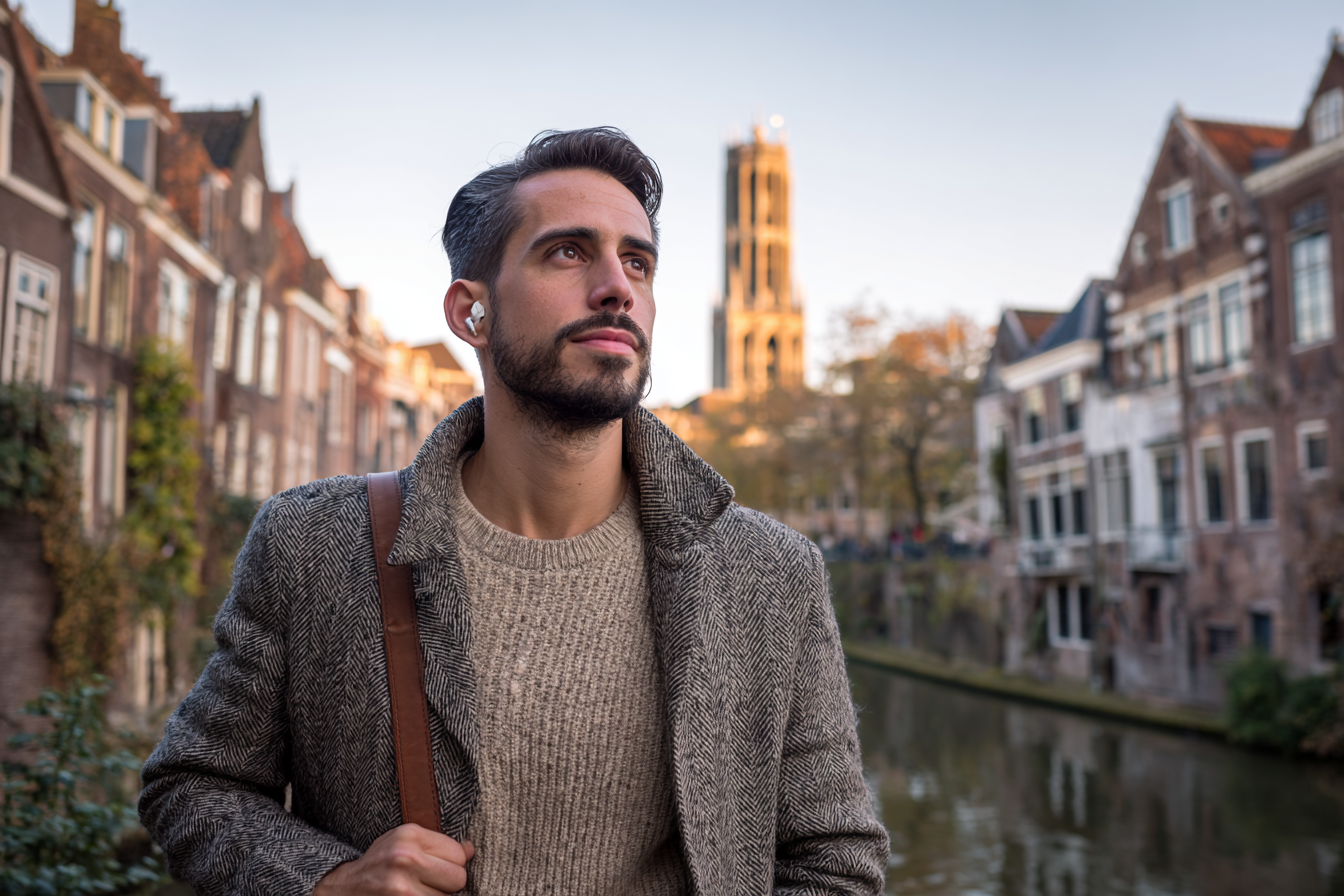 Schema therapy clinician listening to an STTC training podcast along the Oudegracht canal in Utrecht.